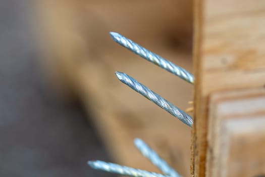 Close up view of Nails coming out of a broken crate. High quality photo