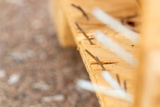 close up view of nails sticking out of a broken Crate. High quality photo