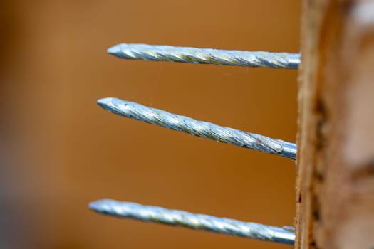 Group of three nails thru a crate close up. High quality photo