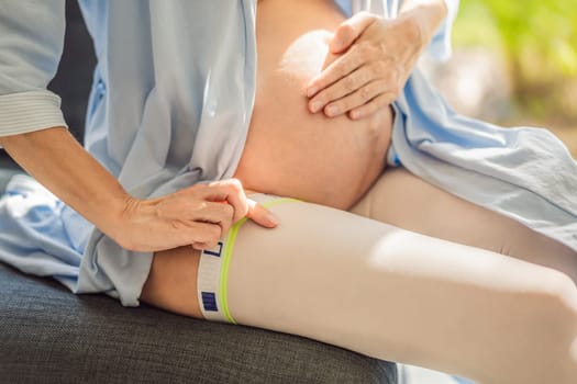 A content and comfortable pregnant woman wearing compression stockings, ensuring better leg health and support during her pregnancy journey.