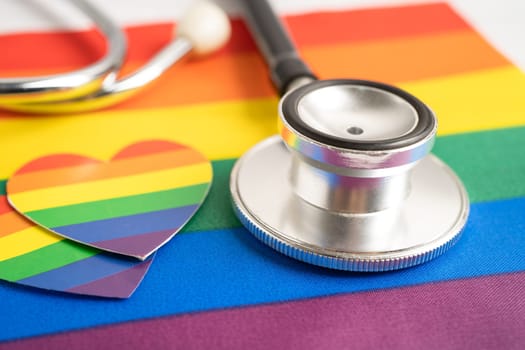 Black stethoscope on rainbow flag with heart, symbol of LGBT pride month celebrate annual in June social, symbol of gay, lesbian, bisexual, transgender, human rights and peace.