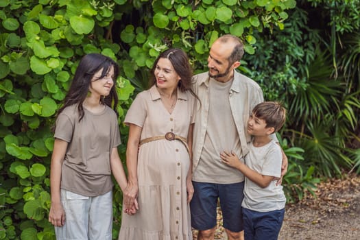 A loving family enjoying a leisurely walk in the park - a radiant pregnant woman after 40, embraced by her husband, and accompanied by their adult teenage children, savoring precious moments together amidst nature's beauty. Pregnancy after 40 concept.