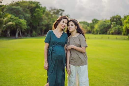 A heartwarming moment captured in the park as a pregnant woman after 40 shares a special bond with her teenage daughter, embracing the beauty of mother-daughter connection.