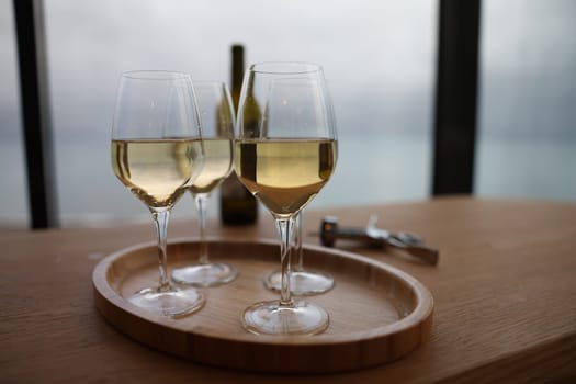 Glasses on tray with elite white wine. Wine selection rules