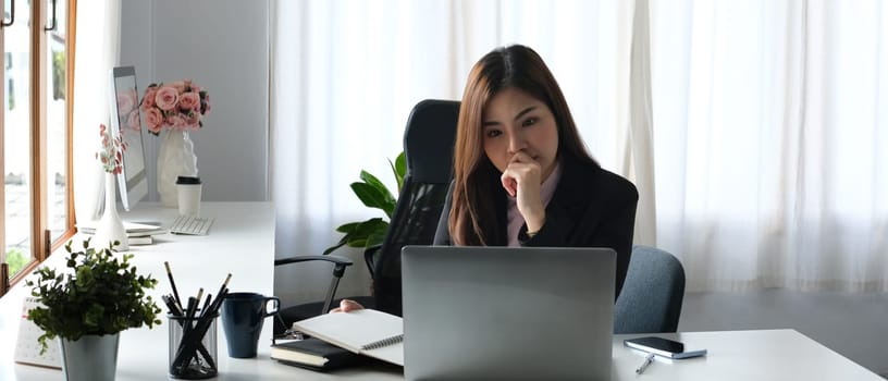 Beautiful asian woman entrepreneur working on investment and marketing projects at modern office.