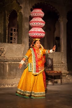 UDAIPUR, INDIA - NOVEMBER 24, 2012: Bhavai performance - famous folk dance of Rajasthan state of India. Performer balances number of earthen pots as she dance. November 24, 2012 in Udaipur, Rajasthan, India