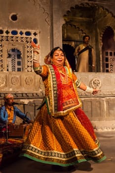 UDAIPUR, INDIA - NOVEMBER 24, 2012: Bhavai performance - famous folk dance of Rajasthan state of India. Performer balances number of earthen pots as she dance. November 24, 2012 in Udaipur, Rajasthan, India