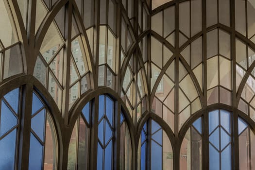 Antique multicolored stained glass window panel are decorated in monastery chapel. Vintage pattern stained-glass background, Selective focus.