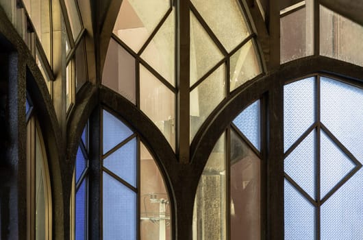 Antique multicolored stained glass window panel are decorated in monastery chapel. Vintage pattern stained-glass background, Selective focus.