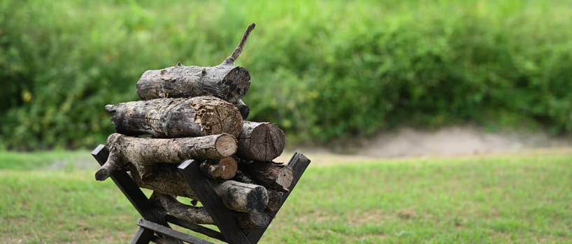 Pile of firewood in campsite, tourism, recreation outside, camping and travel concept.