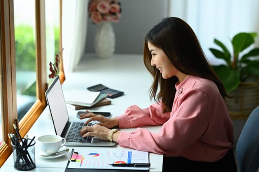 Beautiful asian woman entrepreneur working on investment and marketing projects at modern office.