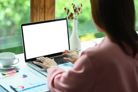 Cropped shot of creative woman hand typing on laptop computer, working on project at office.