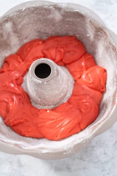 Filling bundt cake pan with red, white, and blue cake dought to bake July 4th bundt cake with chocolate stars.