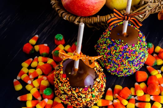 Hand dipped caramel apple covered with multi color sprinkles.