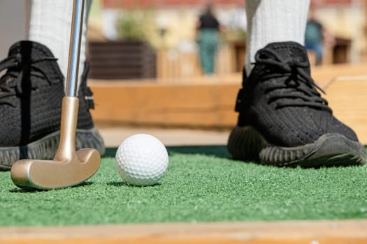 Summer hobbies. unrecognizable person playing mini golf