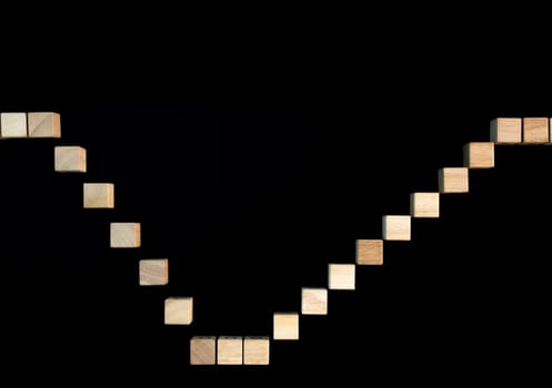 wooden blocks arranged like stair steps on a black background