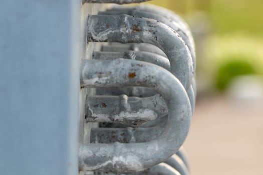 water end flow coil tubes from a large air conditioner close up background . High quality photo