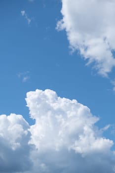 Big white clouds in a blue sky close-up. There is a place for the text. The concept of cleanliness in nature and caring for nature