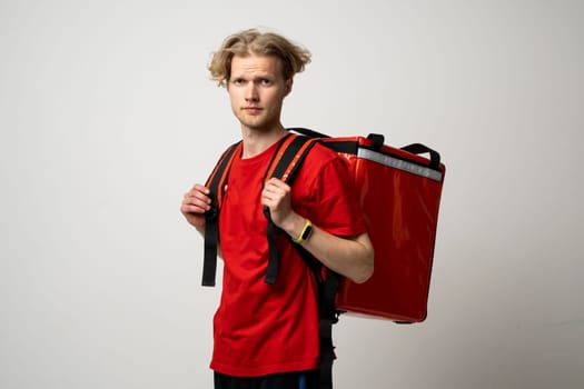 Young courier man with thermo bag on white background. Food delivery service. Food Delivery
