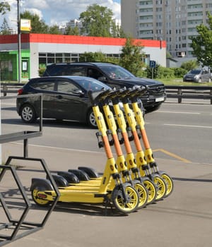 Moscow, Russia - July 21. 2023. Yandex go company electric scooters on the background of the road with cars in Zelenograd