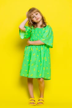 Young school girl feeling hopelessness loneliness, nervous breakdown, loses play game surprised by lottery results, bad fortune, loss, unlucky news. Preteen child kid on yellow background. Vertical