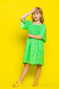 Face palm. Shame on you. Upset young blonde child girl kid making face palm gesture, feeling bored, disappointed in result, bad news. Little preteen children isolated on yellow background. Vertical