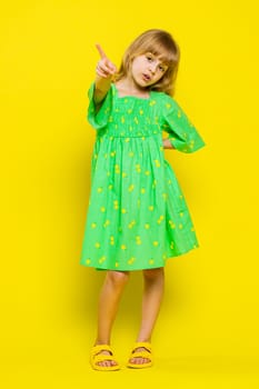 Displeased upset child girl kid reacting to unpleasant awful idea, dissatisfied with bad quality, wave finger shake No dismiss idea, dont like proposal. Preteen children on yellow background. Vertical