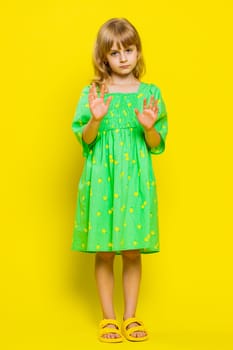 Hey you, be careful. Blonde child girl kid warning with admonishing finger gesture, saying no, be careful, scolding and giving advice to avoid danger, disapproval sign. Preteen children. Vertical