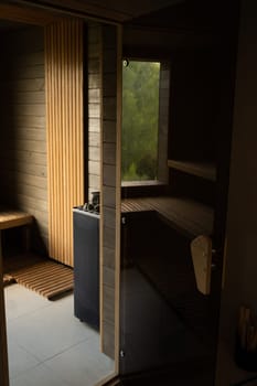 Modern wooden Finnish sauna interior with wooden benches. Wooden interior baths, wooden benches and loungers accessories for sauna, spa complex