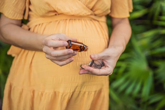 pregnant woman after 40 demonstrating the use of an aroma pendant, combining style and aromatherapy during her pregnancy journey.