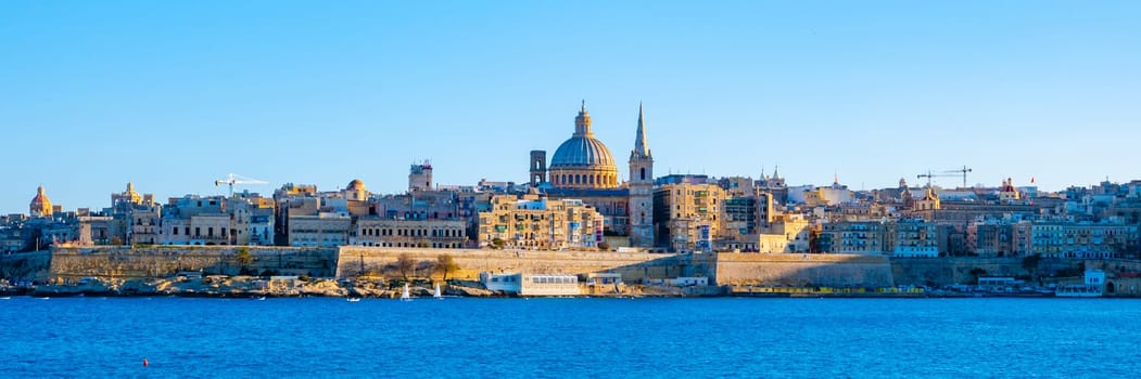 Valletta Malta city Skyline, colorful house balcony Malta Valletta, panoramic view over Valletta Malta old town at sunset