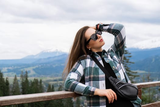 Young woman enjoying nature in Snowy Mountain in Polish Tatry mountains Zakopane Poland. Naturecore aesthetic beautiful green hills. Mental and physical wellbeing Travel outdoors tourist destination