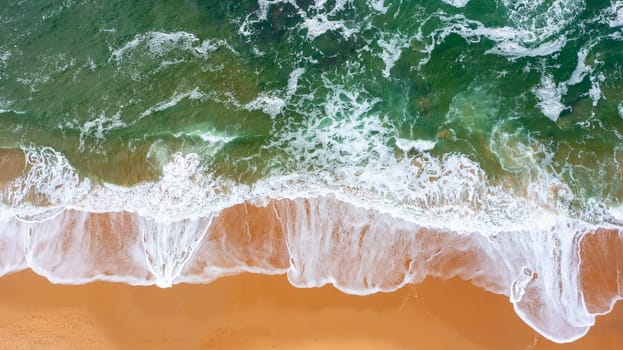 Aerial view of beautiful tropical beach and sea with sand and wave. Turquoise color water