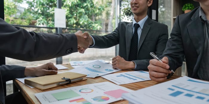 Young asia business shaking hands successful making a deal, business woman handshake. Business partnership meeting handshake concept.