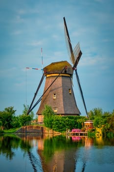 Netherlands rural lanscape with windmills at famous tourist site Kinderdijk in Holland on sunset with dramatic sky