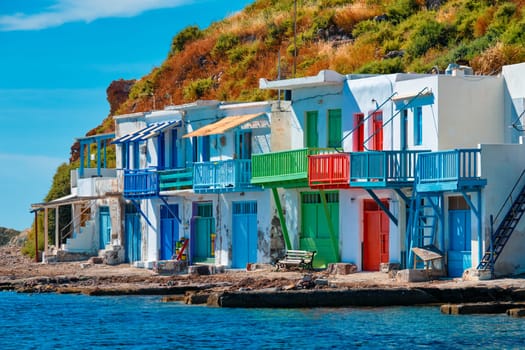 Scenic picturesque greek fishing village Klima with whitewashed traditional houses and colorful windows and doors on Milos island in Greece