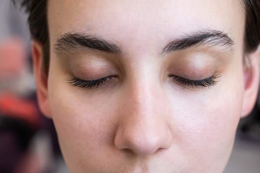 Close-up of a caucasian woman after eyelash lamination procedure