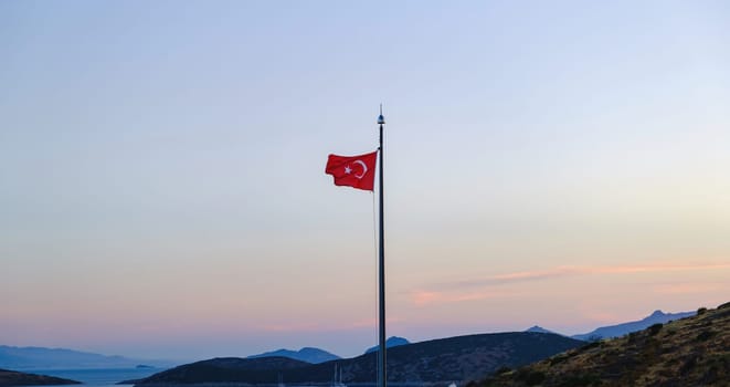 Turkey national flag waving in beautiful sunset colors. Turkey flag waving on a background of mountain. download photo
