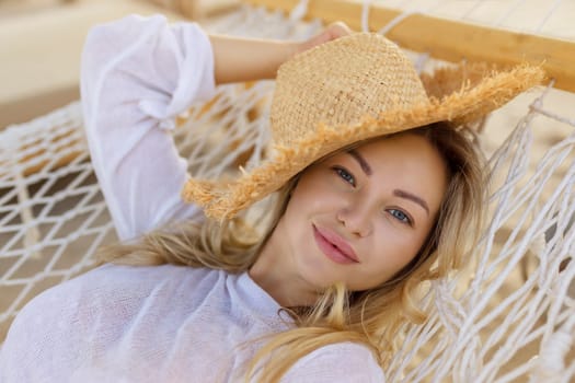 Young beautiful woman relaxing on the hammock.