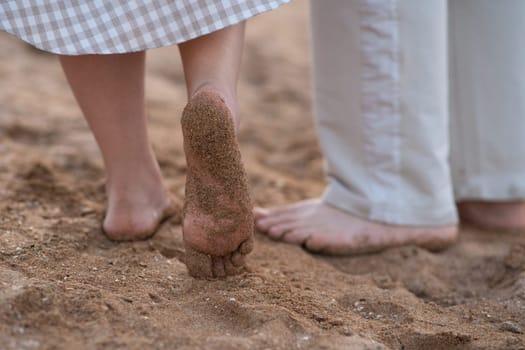 Sand on the feet and heels on the coast