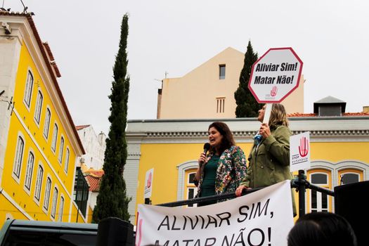 Lisbon, Portugal- May 24, 2018: Demonstrators protesting with placards against euthanasia and asking for palliative care at the doors of the Assembly of the Republic in Lisbon, Portugal
