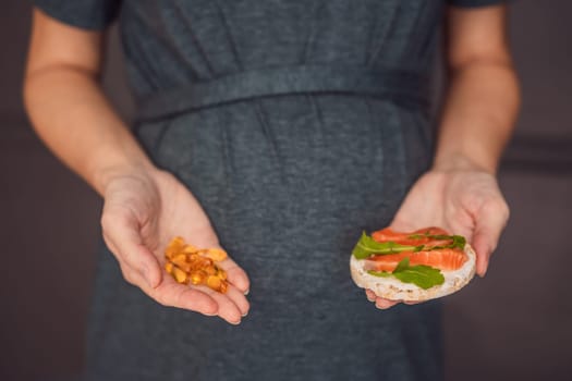 A thoughtful pregnant woman over 40 considering whether to eat fish or opt for omega 3 capsules for a nourishing and healthy pregnancy.