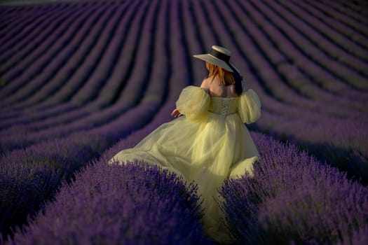 Lavender field happy woman in yellow dress in lavender field summer time at sunset.