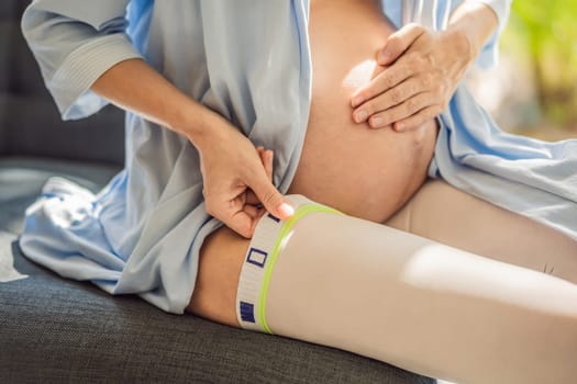 A content and comfortable pregnant woman wearing compression stockings, ensuring better leg health and support during her pregnancy journey.