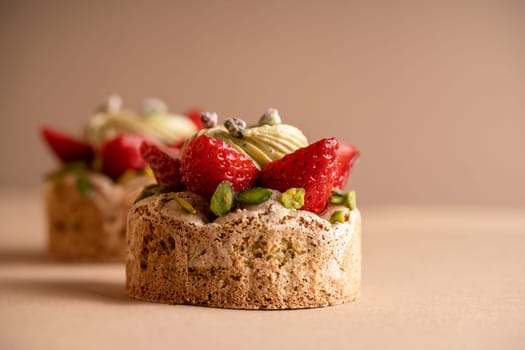 A delicious dessert composed of two decadent strawberry and pistachio cakes