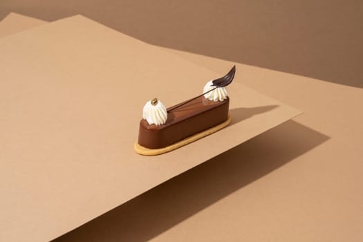 A freshly-baked cake sits atop a table, surrounded by sheets of parchment pape