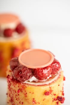 A delicious dessert of raspberry pudding topped with luscious cream and a sweet drizzle