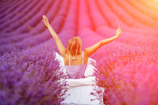 Woman lavender field. A middle-aged woman sits in a lavender field and enjoys aromatherapy. Aromatherapy concept, lavender oil, photo session in lavender.