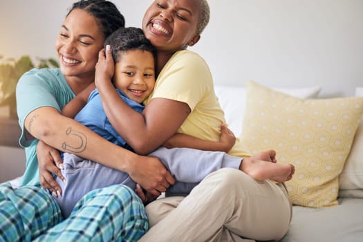 LGBT, bedroom hug and happy family, child and relax mothers bonding, support and enjoy quality time together. Home, care and gay people, homosexual parents or lesbian women embrace young kid on bed.