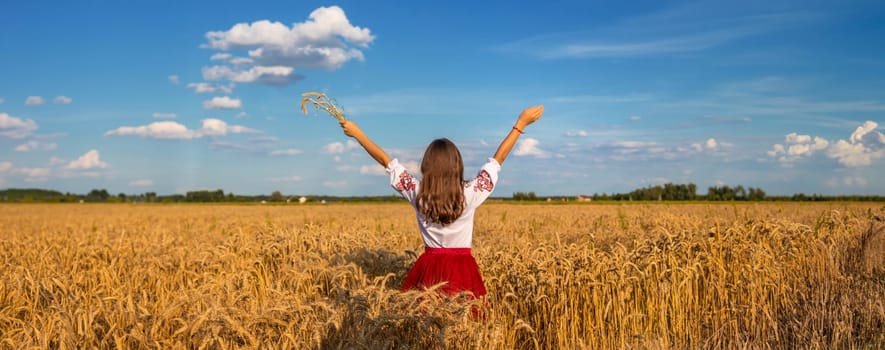 Ukrainian child in vyshyvanka in wheat field. Selective focus. Nature.